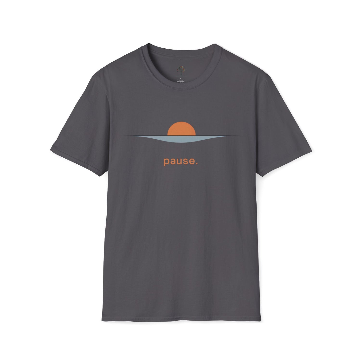 Charcoal unisex t-shirt featuring a minimalist sunrise design — a terracotta half-sun rising over a soft blue-gray horizon wave — with the word "pause." printed below in matching terracotta. Trees & Leaves branded neck label visible at the collar.